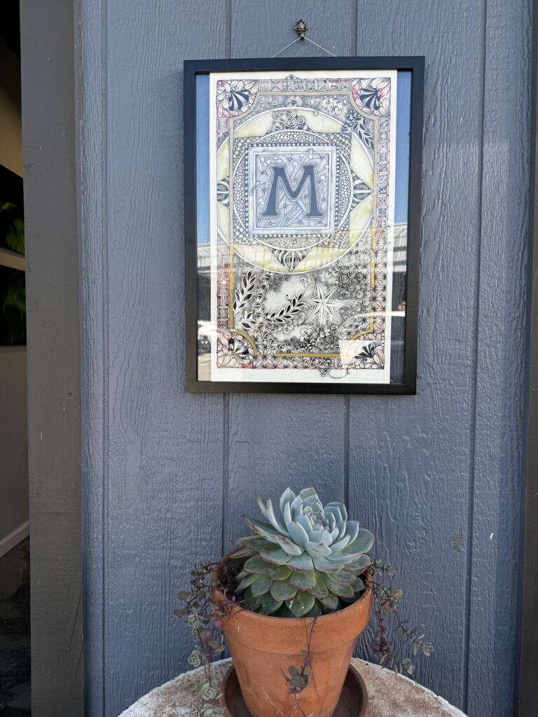 A potted plant sitting on top of a blue wall.