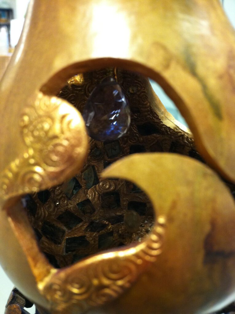 A close up of the inside of a gold object.