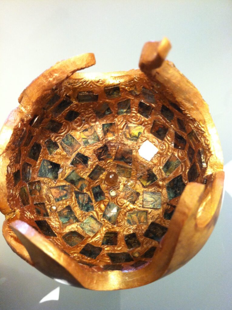 A wooden bowl with some brown and black squares on it