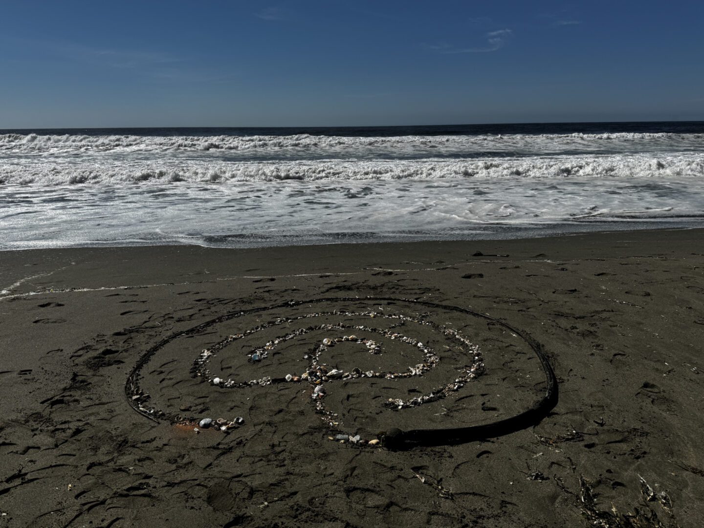 A beach with waves and sand on it